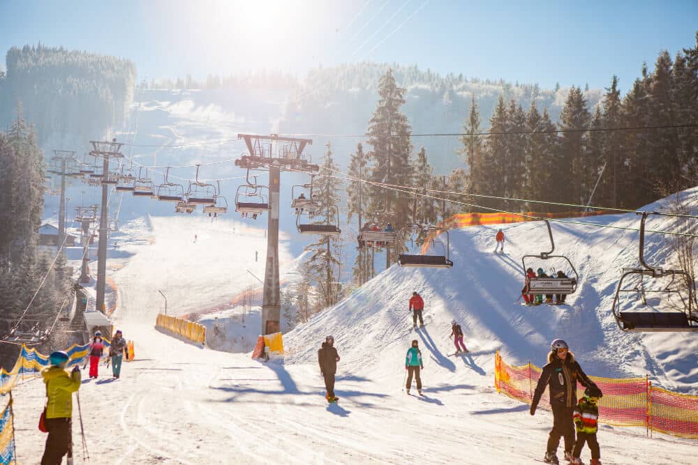skiers on the ski lift riding up at ski resort - Colorado Ski Area Deaths